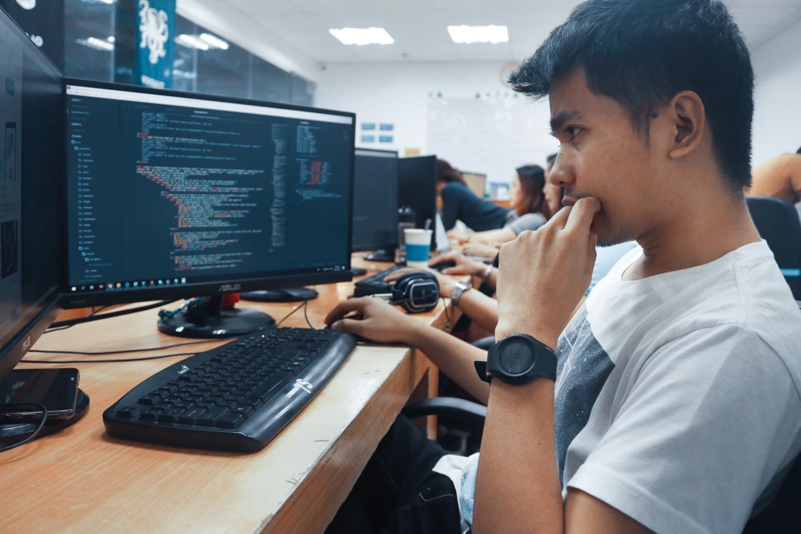 Developer reviewing work on a widescreen monitor